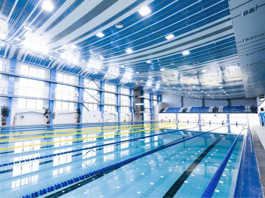 Indoor swimming pool using ozone generator system for water treatment, microbial control, and reduced chemical usage.